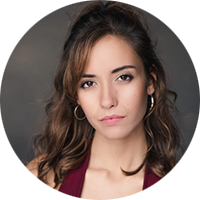 portrait of a woman with brown curly hair wearing a red dress.